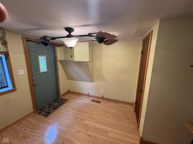 16952 Bookout Rd, Hagerstown, IN 47346 - entrance foyer with light wood-style floors, a ceiling fan, a textured ceiling, and baseboards