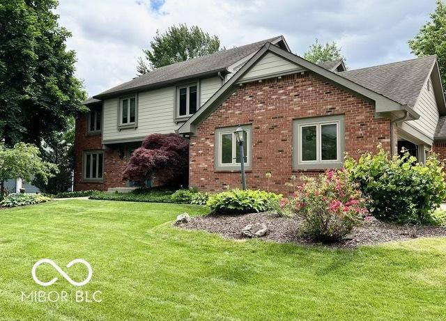 1941 Spruce Dr, Carmel, IN 46033 - rear view of property featuring brick siding and a lawn
