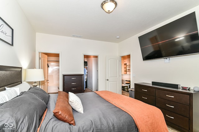 6556 Sulgrove Pl, Indianapolis, IN 46221 - bedroom with a spacious closet, light colored carpet, and ensuite bathroom