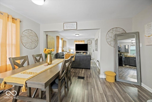 1907 N Drexel Ave, Indianapolis, IN 46218 - dining space featuring dark wood-type flooring and baseboards