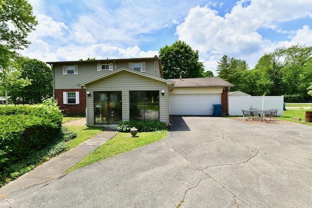 1102 Fox Hill Dr, Indianapolis, IN 46228 - view of front of home featuring brick siding, driveway, and an attached garage