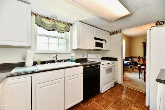 1102 Fox Hill Dr, Indianapolis, IN 46228 - kitchen featuring white appliances, dark countertops, white cabinets, and a textured ceiling