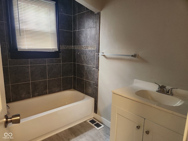 1624 E 30th St, Indianapolis, IN 46218 - bathroom with baseboards, vanity, shower / bathtub combination, and wood finished floors