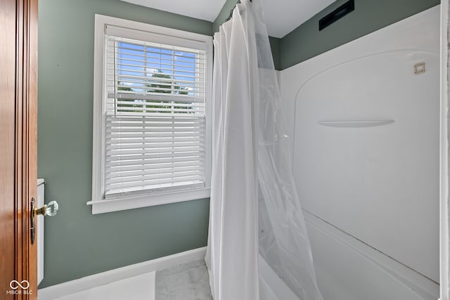 1438 Adams St, Lafayette, IN 47905 - bathroom with baseboards and shower / bathtub combination with curtain