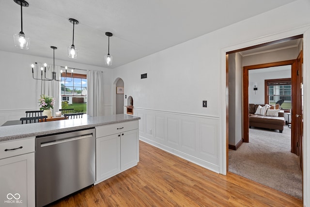 1438 Adams St, Lafayette, IN 47905 - kitchen featuring stainless steel dishwasher, arched walkways, a chandelier, white cabinets, and light countertops