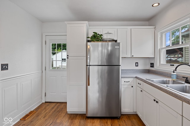 1438 Adams St, Lafayette, IN 47905 - kitchen with freestanding refrigerator, a sink, healthy amount of natural light, white cabinetry, and recessed lighting