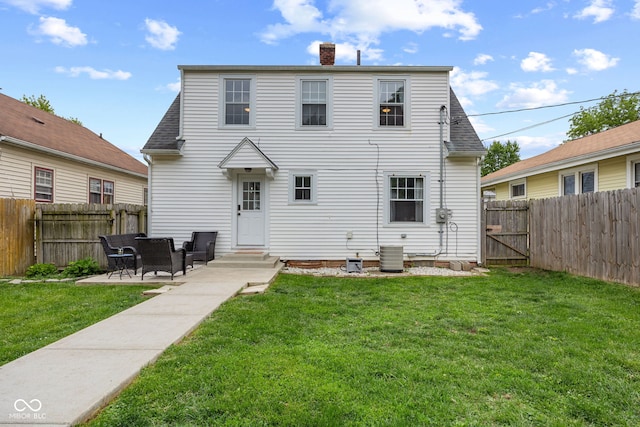1438 Adams St, Lafayette, IN 47905 - back of property featuring a chimney, central AC, a gate, a patio, and roof with shingles