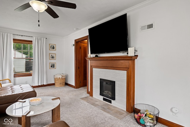 1438 Adams St, Lafayette, IN 47905 - living room featuring carpet flooring, ceiling fan, crown molding, baseboards, and a tile fireplace