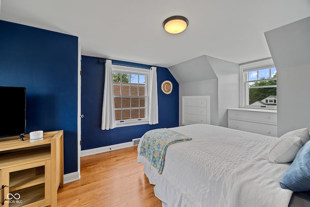 1438 Adams St, Lafayette, IN 47905 - bedroom with wood finished floors, baseboards, and lofted ceiling
