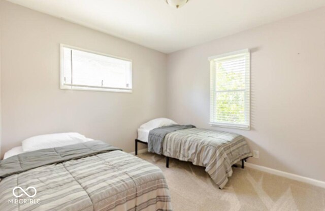1398 Clinton St, Noblesville, IN 46060 - bedroom with multiple windows, baseboards, and carpet floors