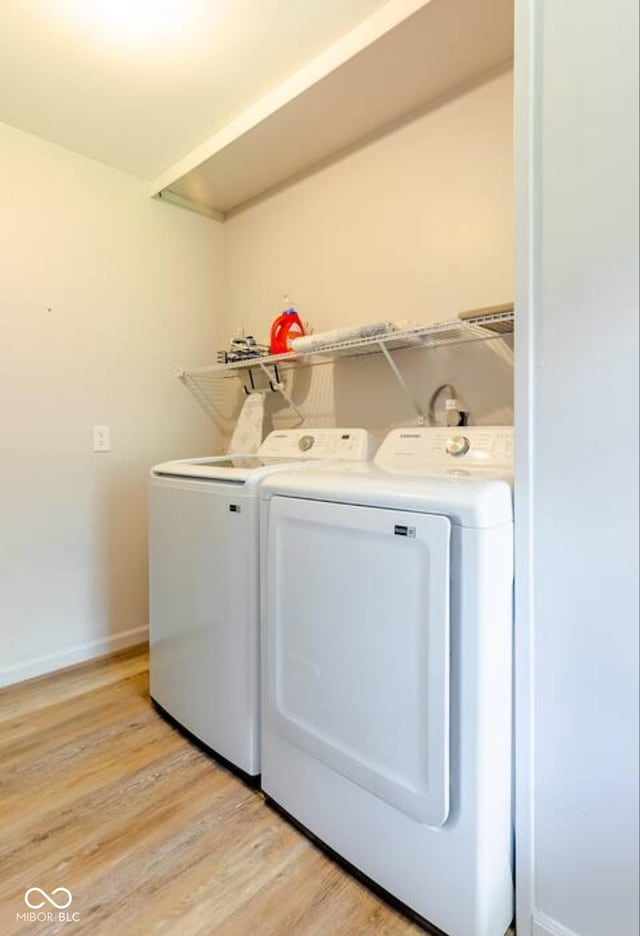 1398 Clinton St, Noblesville, IN 46060 - laundry area with washer and dryer, baseboards, and light wood-style floors