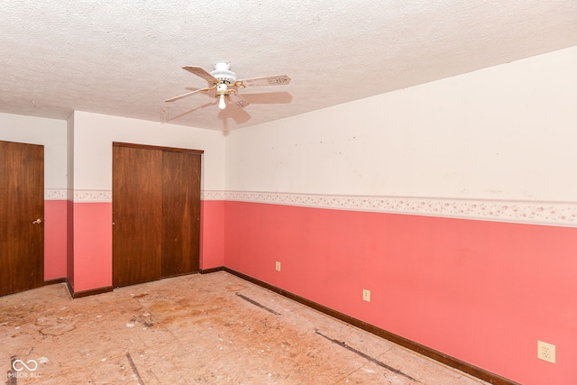 1113 Delray Dr, Indianapolis, IN 46241 - unfurnished bedroom featuring a closet, baseboards, a textured ceiling, and ceiling fan