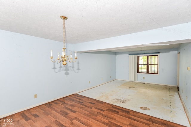 1113 Delray Dr, Indianapolis, IN 46241 - empty room featuring wood finished floors, a chandelier, a textured ceiling, and baseboards