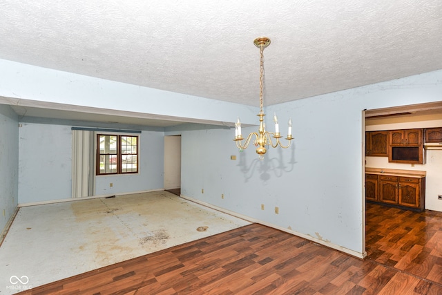 1113 Delray Dr, Indianapolis, IN 46241 - unfurnished dining area with a textured ceiling, wood finished floors, a chandelier, and baseboards