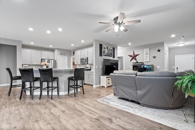 13321 N White Cloud Ct, Camby, IN 46113 - living area featuring light wood-style flooring, recessed lighting, a ceiling fan, and baseboards