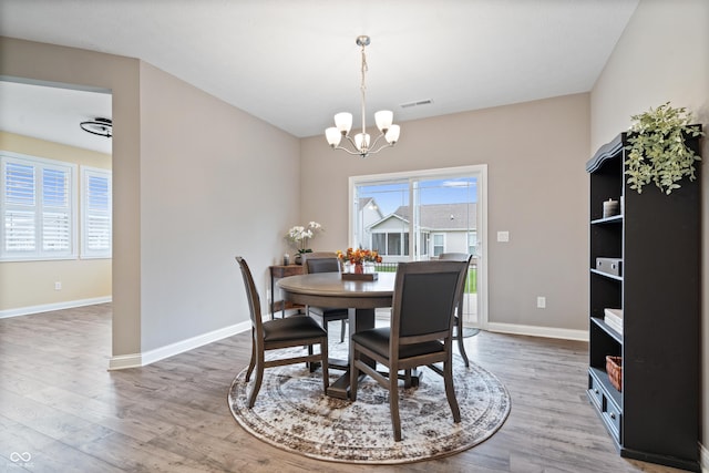 13321 N White Cloud Ct, Camby, IN 46113 - dining room featuring a chandelier, wood finished floors, and baseboards