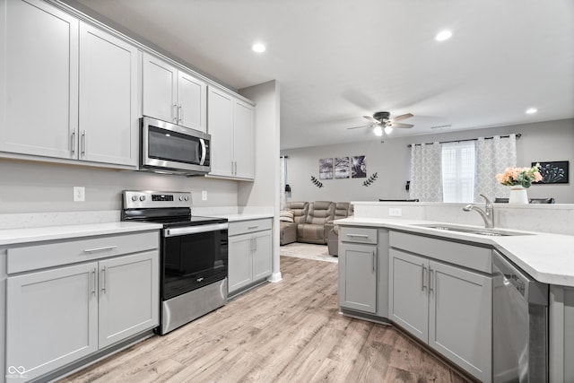 13321 N White Cloud Ct, Camby, IN 46113 - kitchen with stainless steel appliances, a sink, gray cabinets, open floor plan, and a ceiling fan