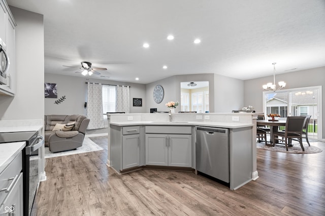 13321 N White Cloud Ct, Camby, IN 46113 - kitchen with stainless steel dishwasher, electric stove, gray cabinets, a sink, and light countertops