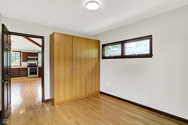 126 E 86th St, Indianapolis, IN 46240 - unfurnished bedroom featuring light wood-style floors, baseboards, and a closet