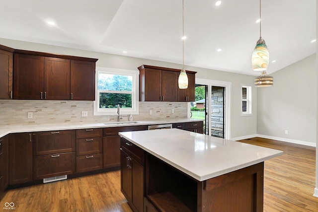 126 E 86th St, Indianapolis, IN 46240 - kitchen featuring a sink, healthy amount of natural light, decorative backsplash, light countertops, and vaulted ceiling