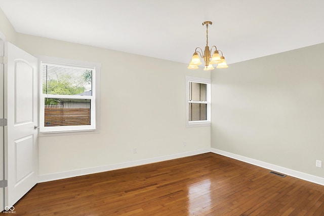 126 E 86th St, Indianapolis, IN 46240 - empty room featuring a chandelier, hardwood / wood-style floors, and baseboards