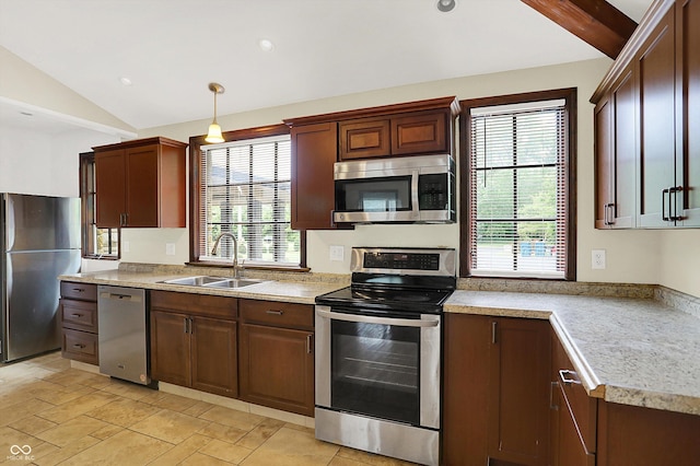 126 E 86th St, Indianapolis, IN 46240 - kitchen featuring stainless steel appliances, vaulted ceiling, a sink, light countertops, and decorative light fixtures