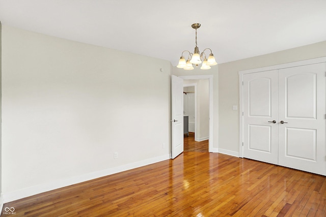 126 E 86th St, Indianapolis, IN 46240 - unfurnished dining area featuring a chandelier, light wood finished floors, and baseboards