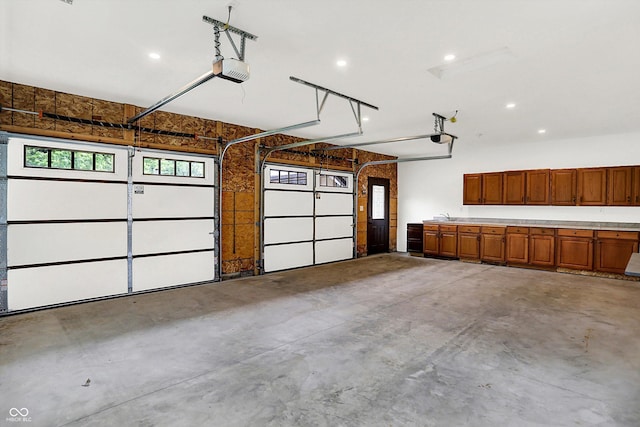 126 E 86th St, Indianapolis, IN 46240 - garage with a garage door opener, recessed lighting, and a sink