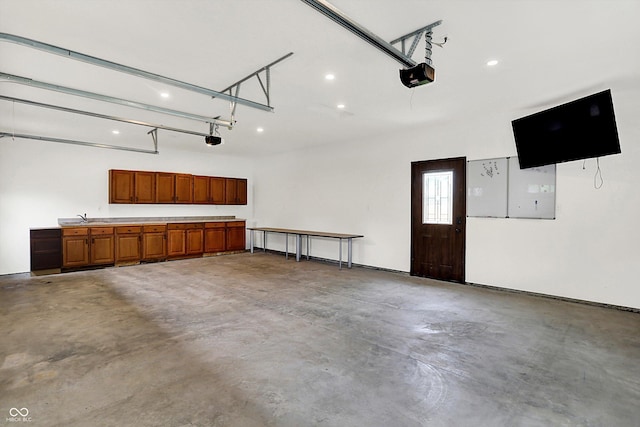 126 E 86th St, Indianapolis, IN 46240 - garage with a garage door opener, recessed lighting, and a sink