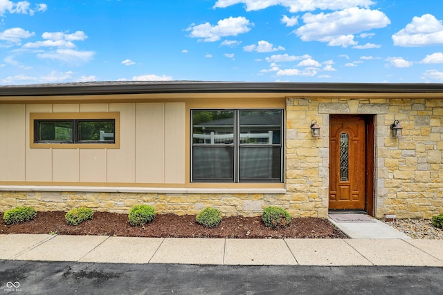 126 E 86th St, Indianapolis, IN 46240 - entrance to property featuring stone siding and board and batten siding