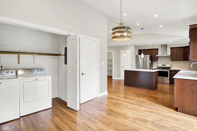126 E 86th St, Indianapolis, IN 46240 - laundry room featuring independent washer and dryer, light wood finished floors, recessed lighting, baseboards, and a chandelier