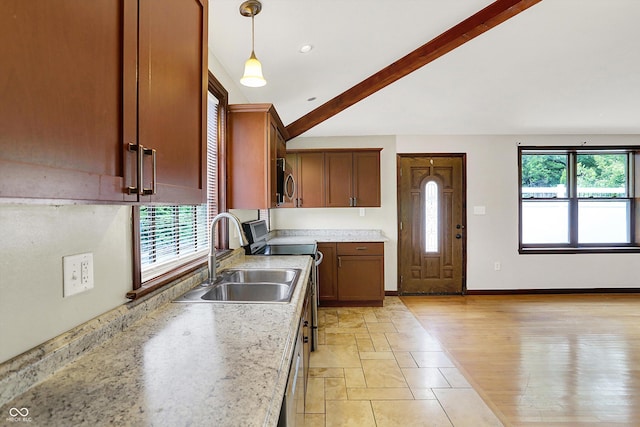 126 E 86th St, Indianapolis, IN 46240 - kitchen with a sink, beam ceiling, light countertops, hanging light fixtures, and baseboards
