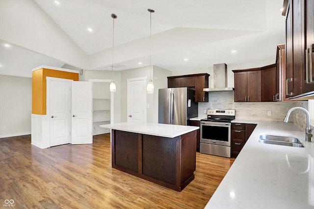 126 E 86th St, Indianapolis, IN 46240 - kitchen featuring stainless steel appliances, wall chimney exhaust hood, a sink, wood finished floors, and dark brown cabinets