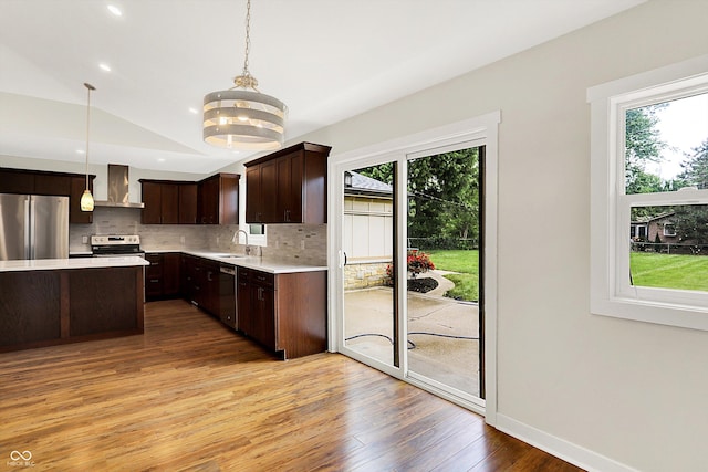 126 E 86th St, Indianapolis, IN 46240 - kitchen with appliances with stainless steel finishes, a sink, wall chimney range hood, light wood finished floors, and light countertops
