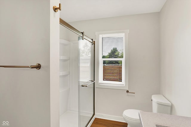 126 E 86th St, Indianapolis, IN 46240 - bathroom featuring toilet, a shower with door, wood finished floors, and baseboards