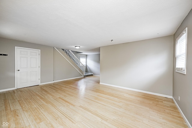 148 S 3rd Ave, Beech Grove, IN 46107 - unfurnished room with stairway, plenty of natural light, and light wood-style flooring