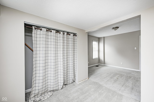 148 S 3rd Ave, Beech Grove, IN 46107 - carpeted spare room featuring baseboards and a textured ceiling