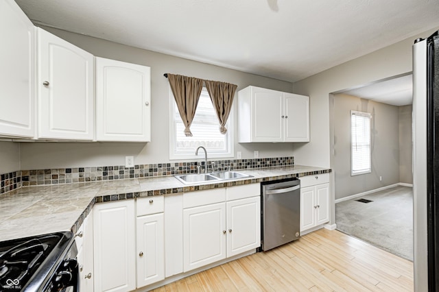 148 S 3rd Ave, Beech Grove, IN 46107 - kitchen featuring stainless steel dishwasher, a sink, gas range oven, and white cabinetry