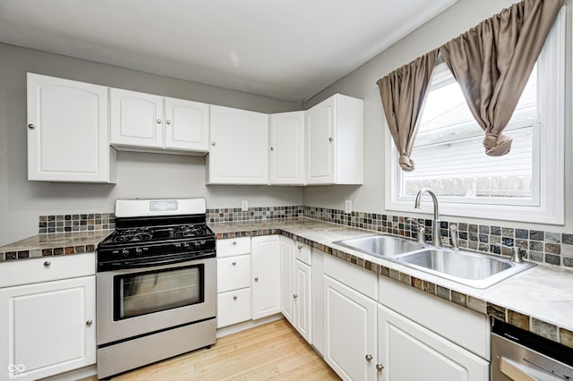 148 S 3rd Ave, Beech Grove, IN 46107 - kitchen featuring gas stove, a sink, white cabinetry, light wood-style flooring, and dishwasher