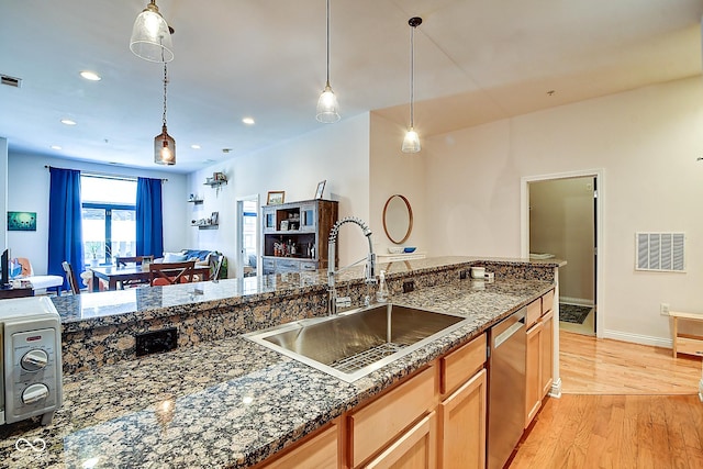 350 N Meridian St Unit A303, Indianapolis, IN 46204 - kitchen featuring a sink, dishwasher, light wood finished floors, decorative light fixtures, and recessed lighting
