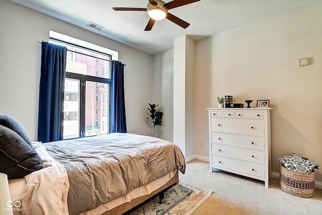 350 N Meridian St Unit A303, Indianapolis, IN 46204 - bedroom with light carpet, baseboards, and a ceiling fan