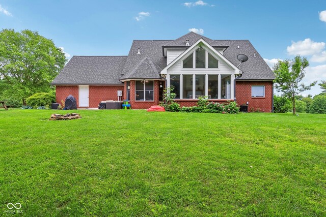 3564 Clear Creek Blvd, Martinsville, IN 46151 - back of house featuring brick siding, a sunroom, and a yard