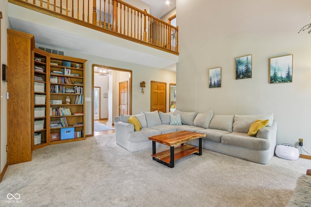 3564 Clear Creek Blvd, Martinsville, IN 46151 - living area with a towering ceiling, carpet floors, baseboards, and a chandelier