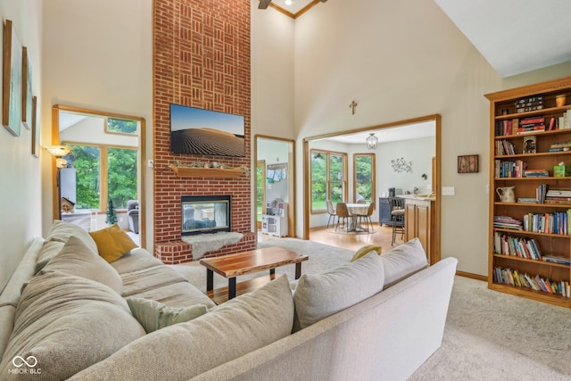 3564 Clear Creek Blvd, Martinsville, IN 46151 - carpeted living area with a towering ceiling, a fireplace, and baseboards