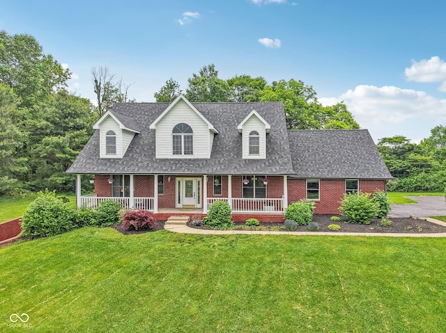 3564 Clear Creek Blvd, Martinsville, IN 46151 - new england style home featuring brick siding, covered porch, a shingled roof, and a front yard