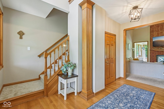 3564 Clear Creek Blvd, Martinsville, IN 46151 - entrance foyer with light wood-style floors, stairway, baseboards, a chandelier, and a fireplace