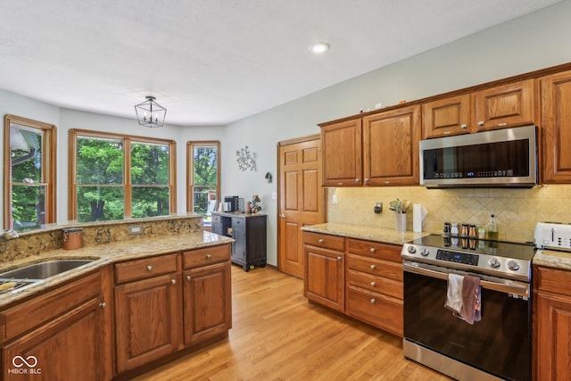3564 Clear Creek Blvd, Martinsville, IN 46151 - kitchen with appliances with stainless steel finishes, tasteful backsplash, light wood-style flooring, brown cabinets, and recessed lighting