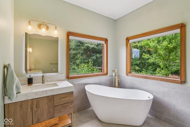 3564 Clear Creek Blvd, Martinsville, IN 46151 - full bath featuring tile walls, a soaking tub, vanity, and tile patterned floors