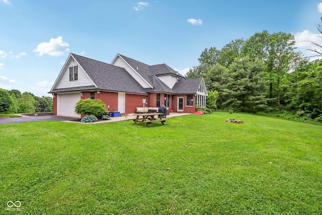 3564 Clear Creek Blvd, Martinsville, IN 46151 - back of property featuring a garage, brick siding, driveway, and a yard