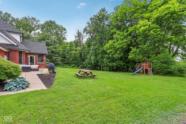 3564 Clear Creek Blvd, Martinsville, IN 46151 - view of green lawn featuring a playground, a patio, and an outdoor living space